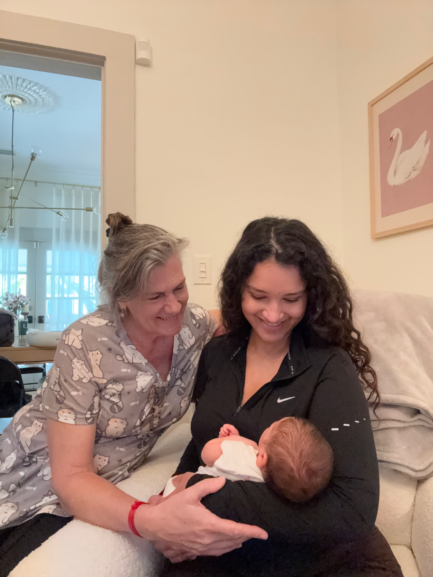 Marina Langesfeld helping a mother latch her baby during an in-home lactation visit